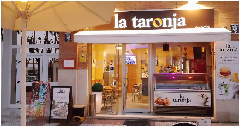 Front of La Taronja 2 with the sign, the ice cream display and the awning